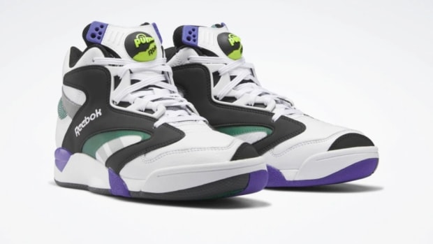View of white, black, and purple Reebok shoes.